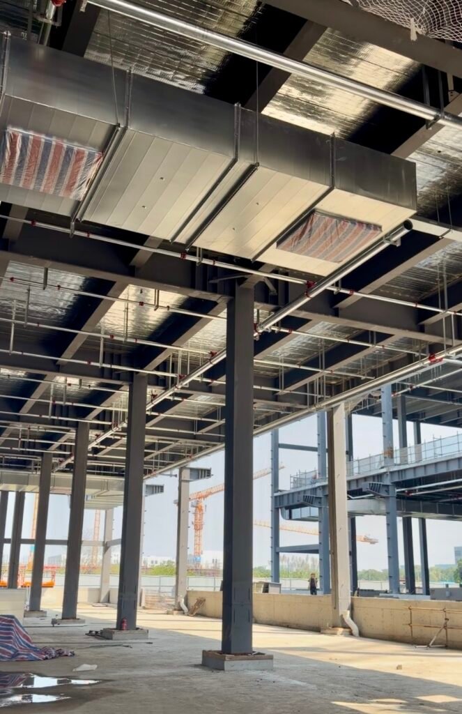 Warehouses and Manufacturing Facilities of a Cosmetics Company – Steel Building in Shanghai, China Interior steel beams and overhead building services at the Shanghai project